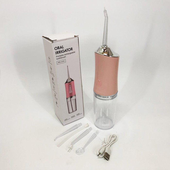 Іригатор для чищення зубів та порожнини рота Oral Irrigator з акумулятором та змінними насадками. Колір: рожевий WP-96