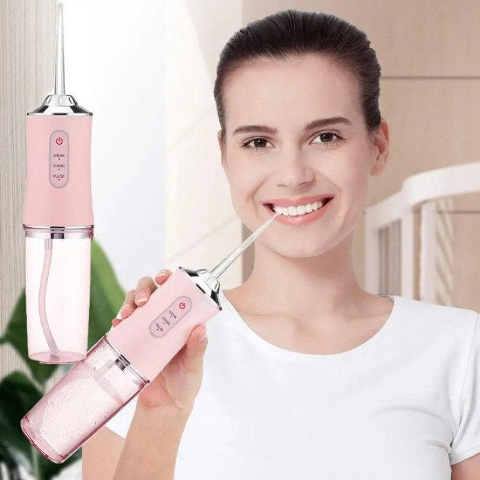 Іригатор для чищення зубів та порожнини рота Oral Irrigator з акумулятором та змінними насадками. Колір: рожевий YR-17